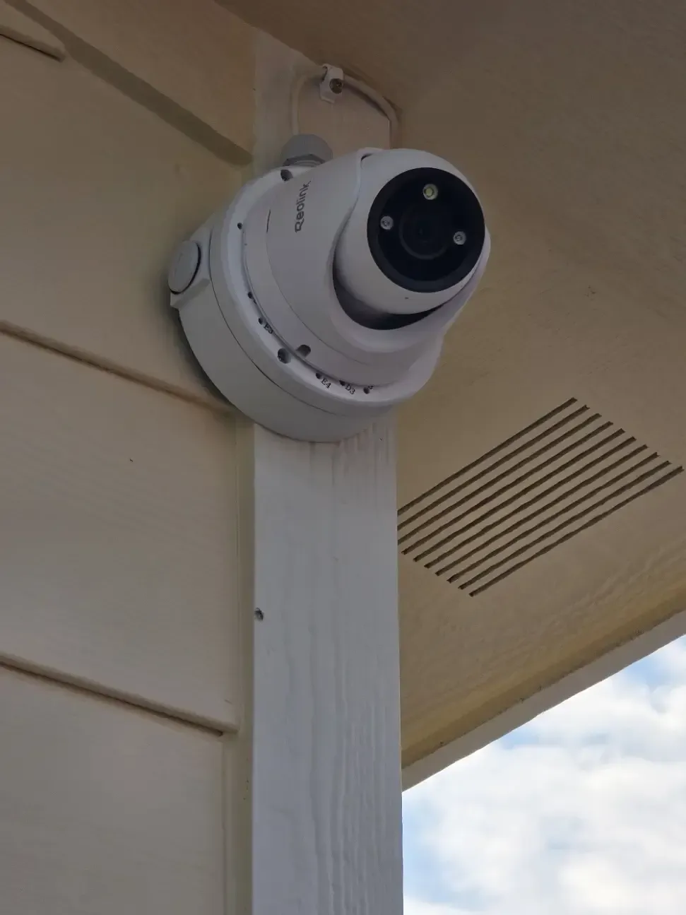 Reolink turret security camera mounted under eave for outdoor surveillance on Missoula Montana residence