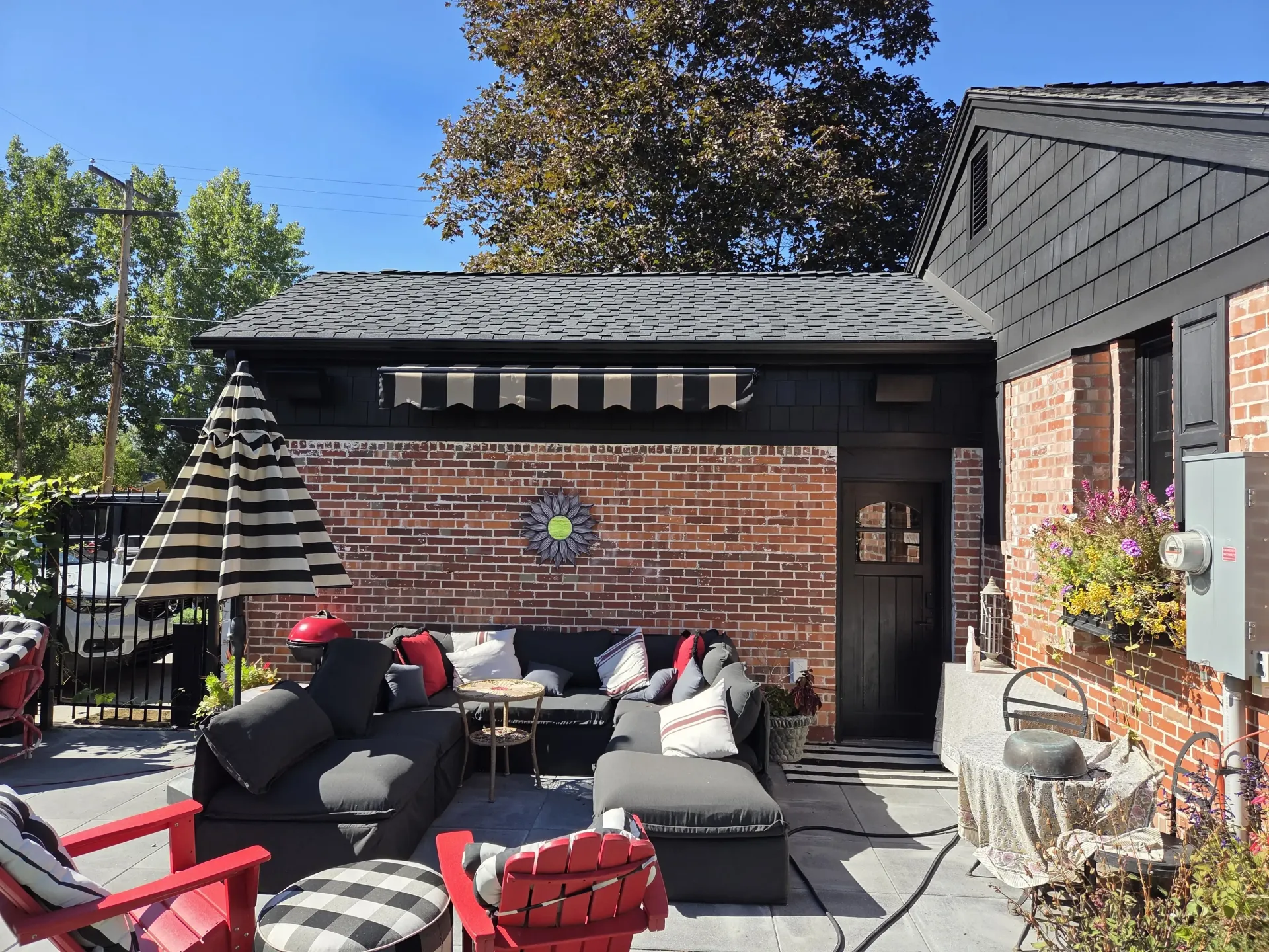 Professional outdoor patio design with pergola seating area and brick exterior landscaping