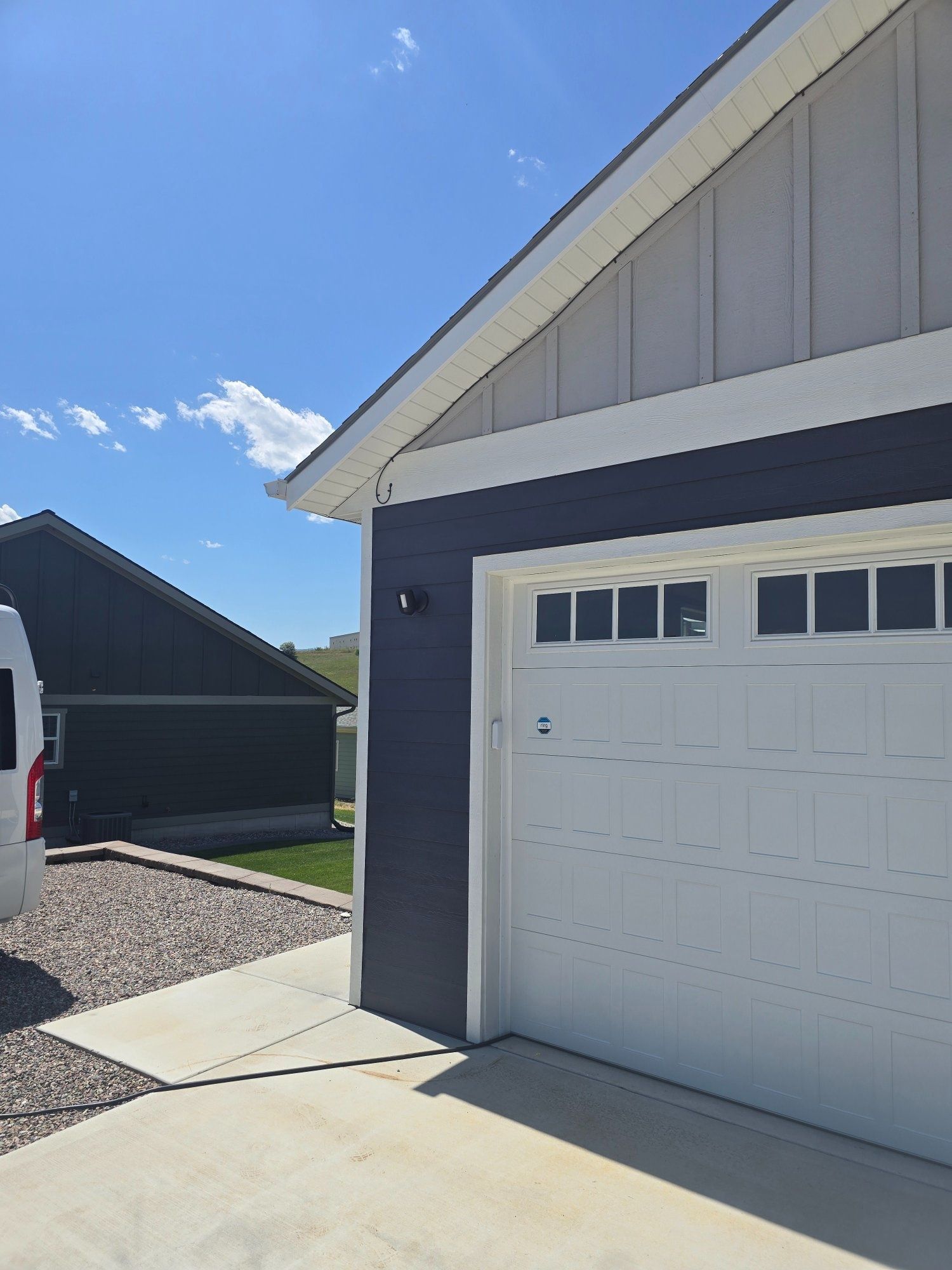 Outdoor security camera and floodlight installation on garage exterior in Wye, Montana — Smart Home Solutions Missoula MT
