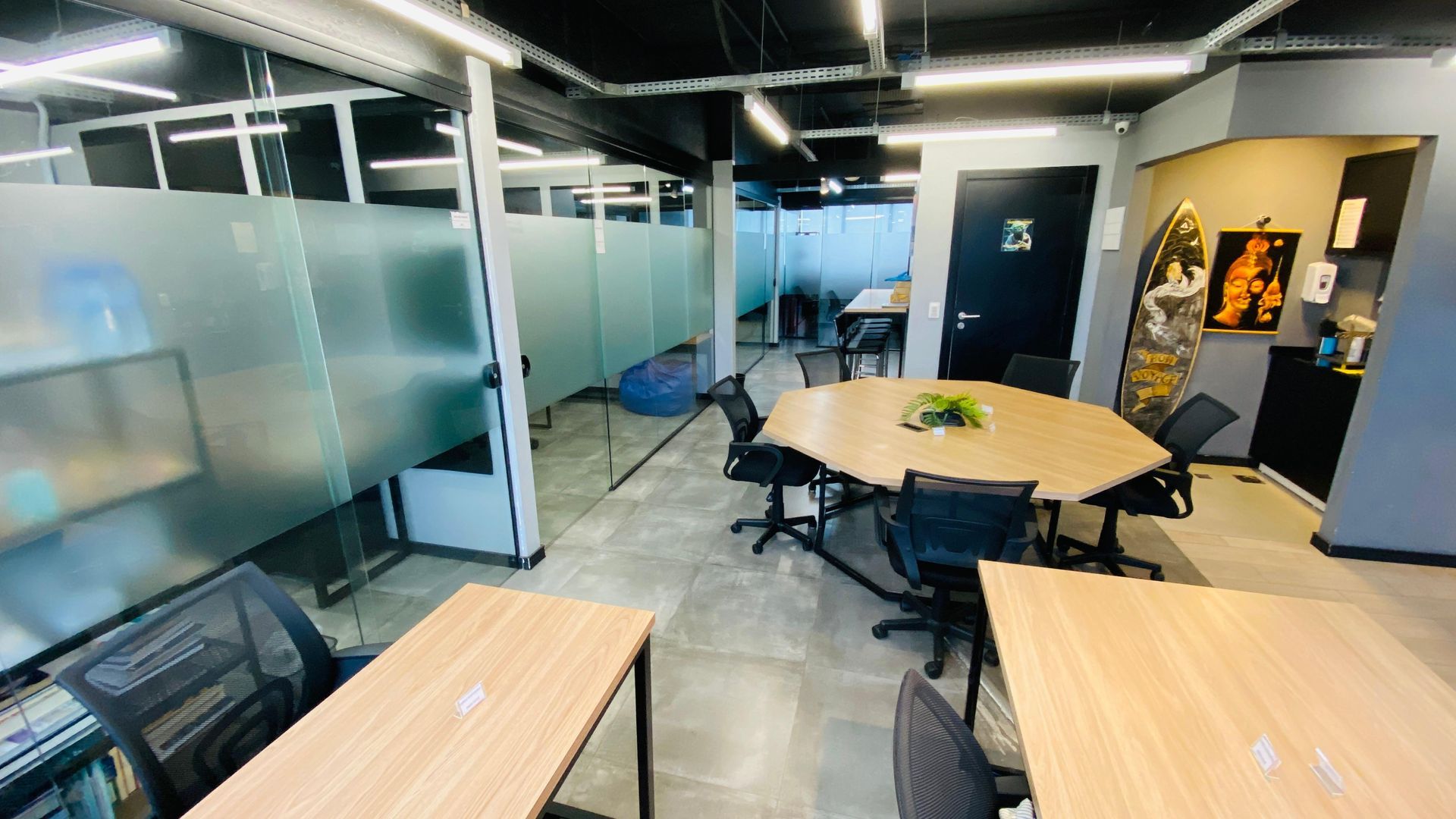 Há muitas mesas e cadeiras na sala.