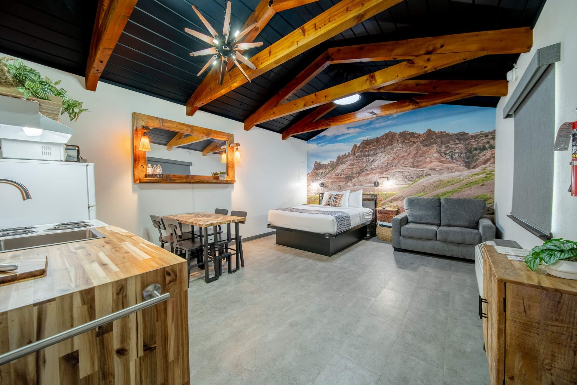 A bed with a wooden map of the state of texas on the wall above it