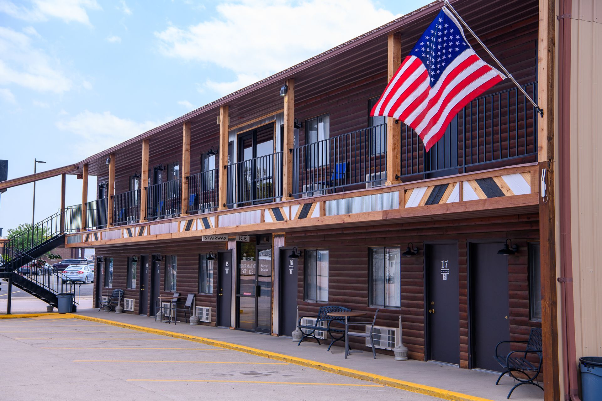 An american flag is flying in front of a motel.