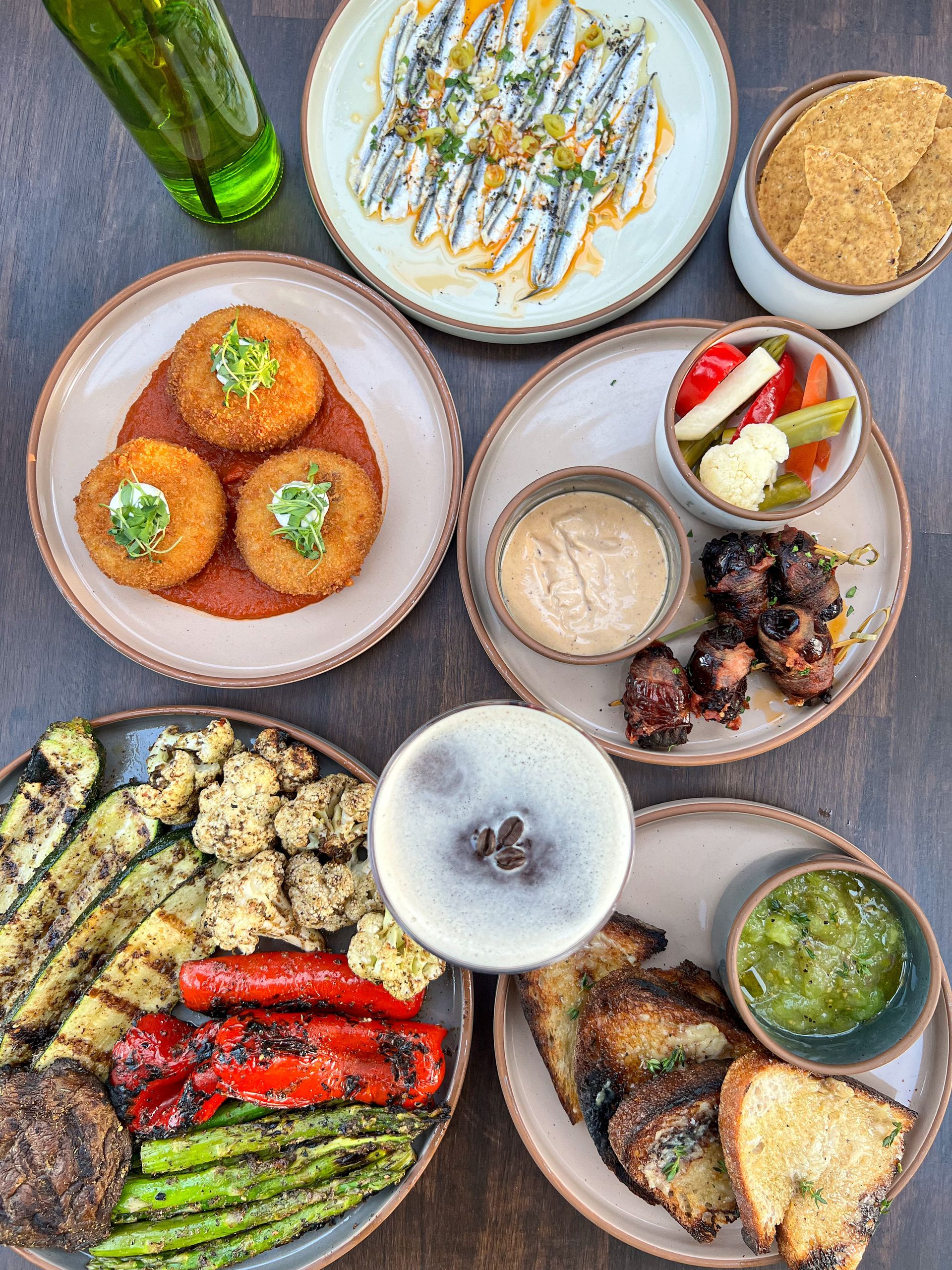 Spanish tapas of croquettas, boquerones, bacon wrapped dates at behind hospitality