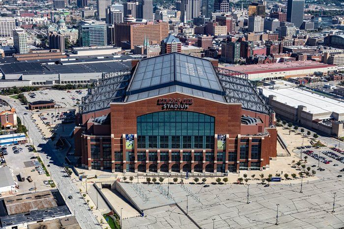 An aerial view of a large brick building in the middle of a city.