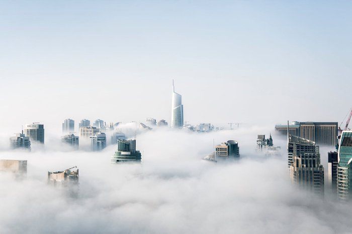 An aerial view of a city covered in fog.