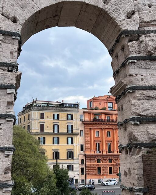 A view of a city through a stone archway