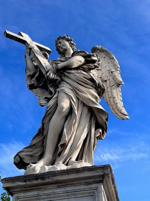 upward view of an angel statue on a Roman bridge