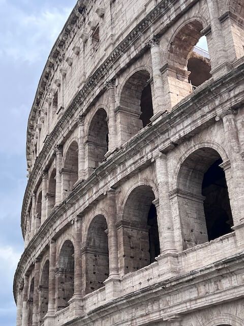 A close up of the side of the colosseum in rome.