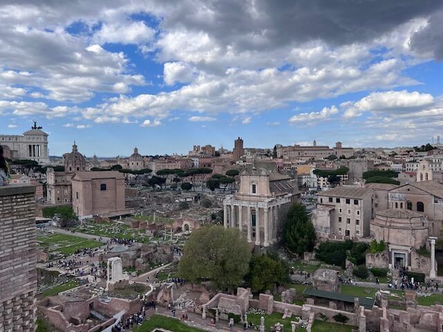 An aerial view of a city with a blue sky and clouds.