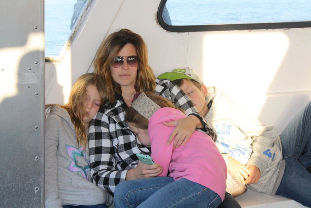 Woman sitting with her three kids