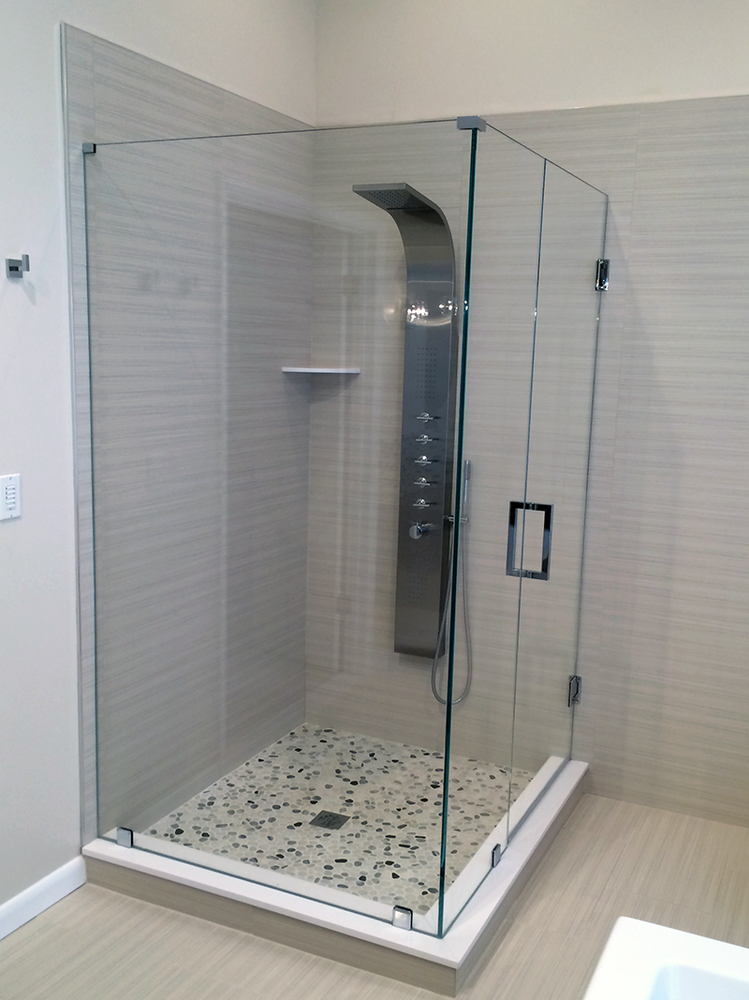 A bathroom with a walk in shower and a shower head.
