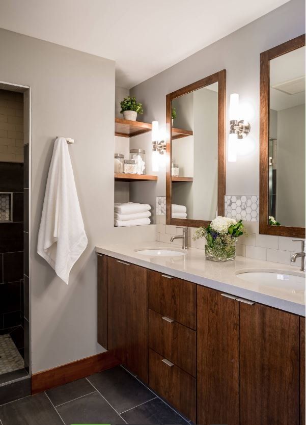 A bathroom with two sinks and two mirrors