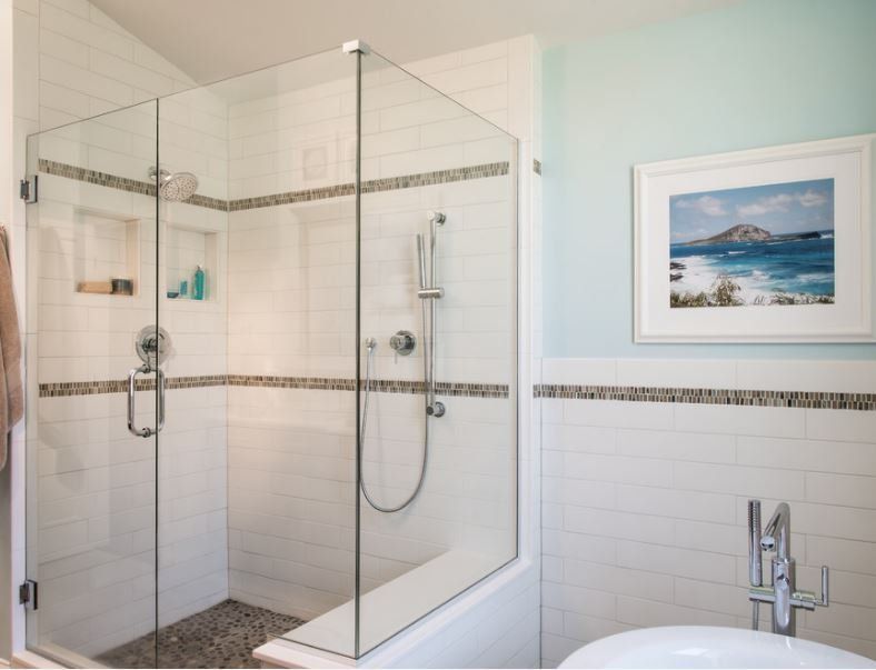 A bathroom with a picture of the ocean on the wall