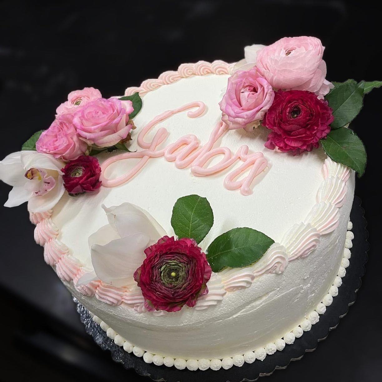 Torta decorata con fiori rosa e scritta 