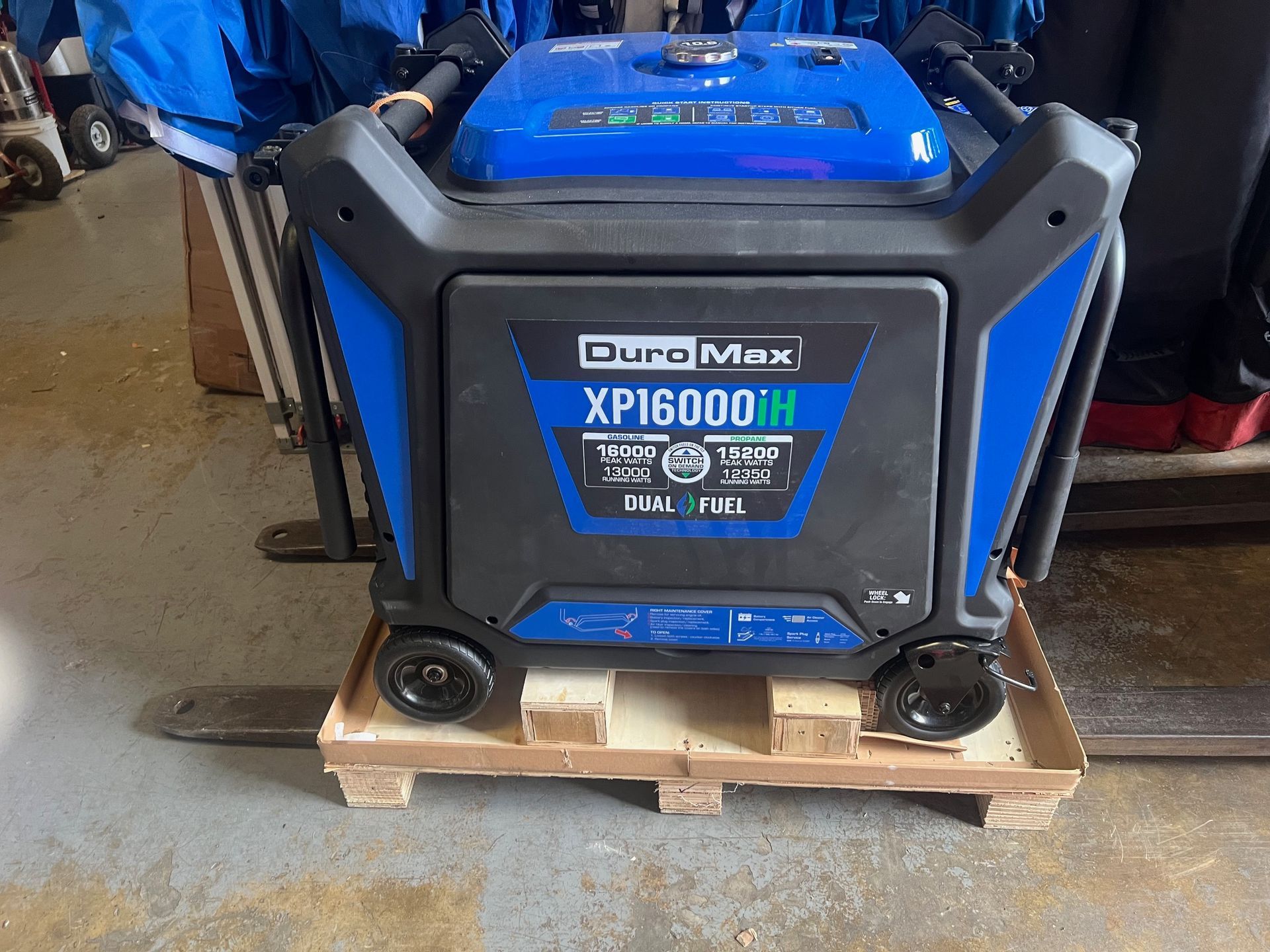 Blue and black DuraMax XP16000H generator on a pallet with wheels.