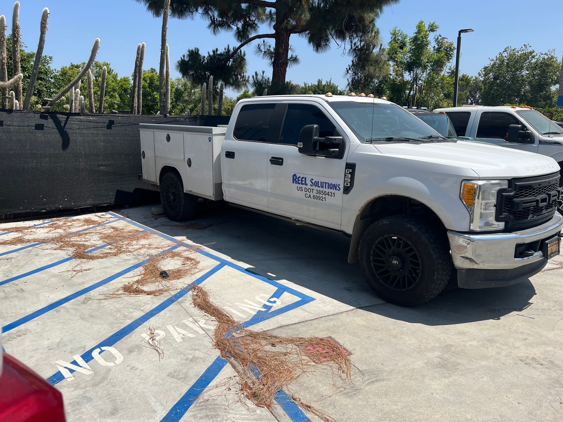 White work truck parked in a marked space with a 