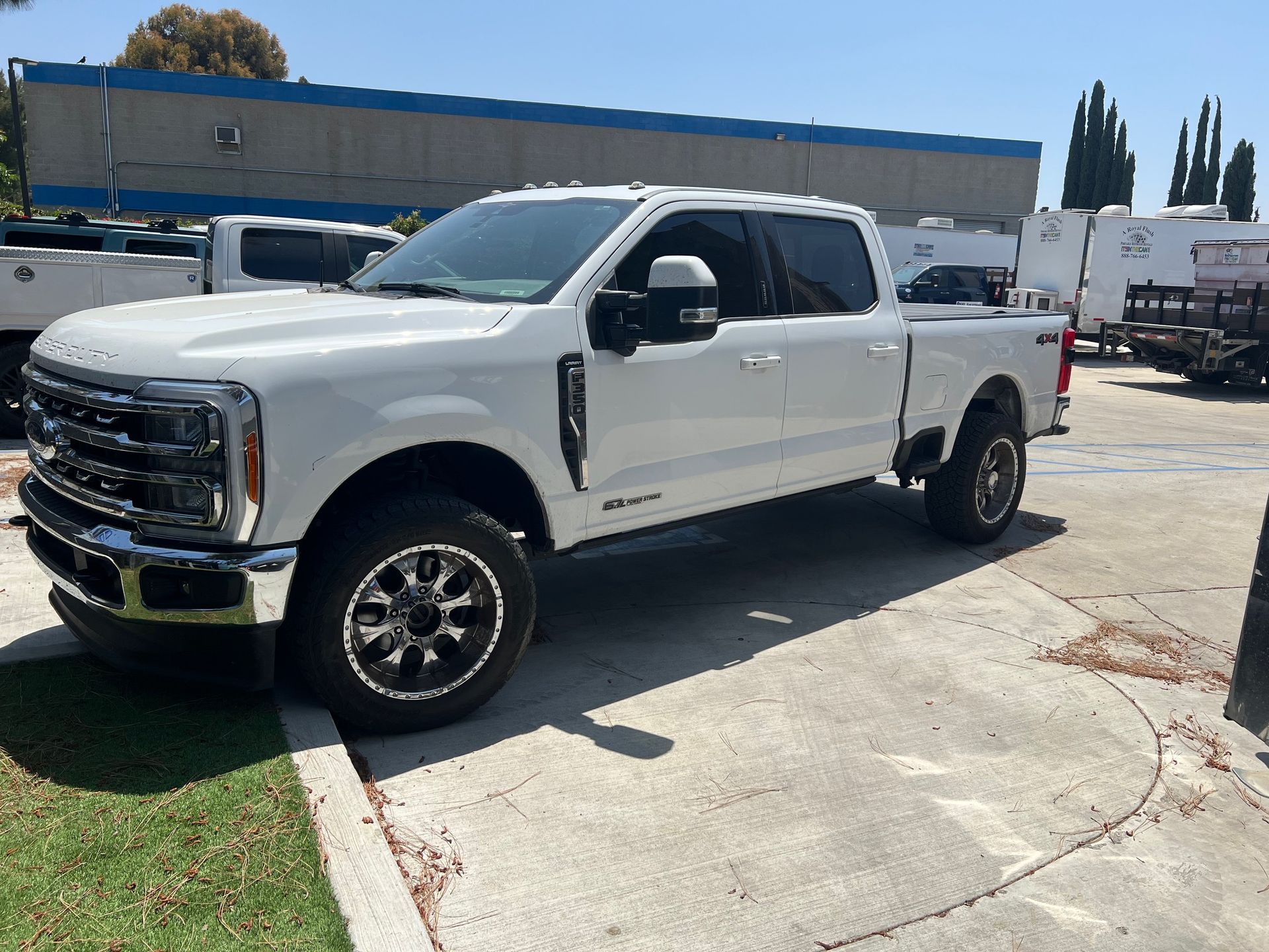 White Ford pickup truck parked outdoors on a sunny day.