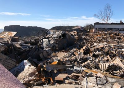 Debris of a destroyed building with a blue sky background.