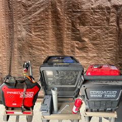 Three generators: red Predator 3500i, black/blue Yamaha, and black Predator 7250. Set on carts against a brown backdrop.
