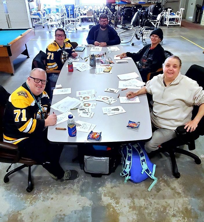 A group of people are sitting around a table.