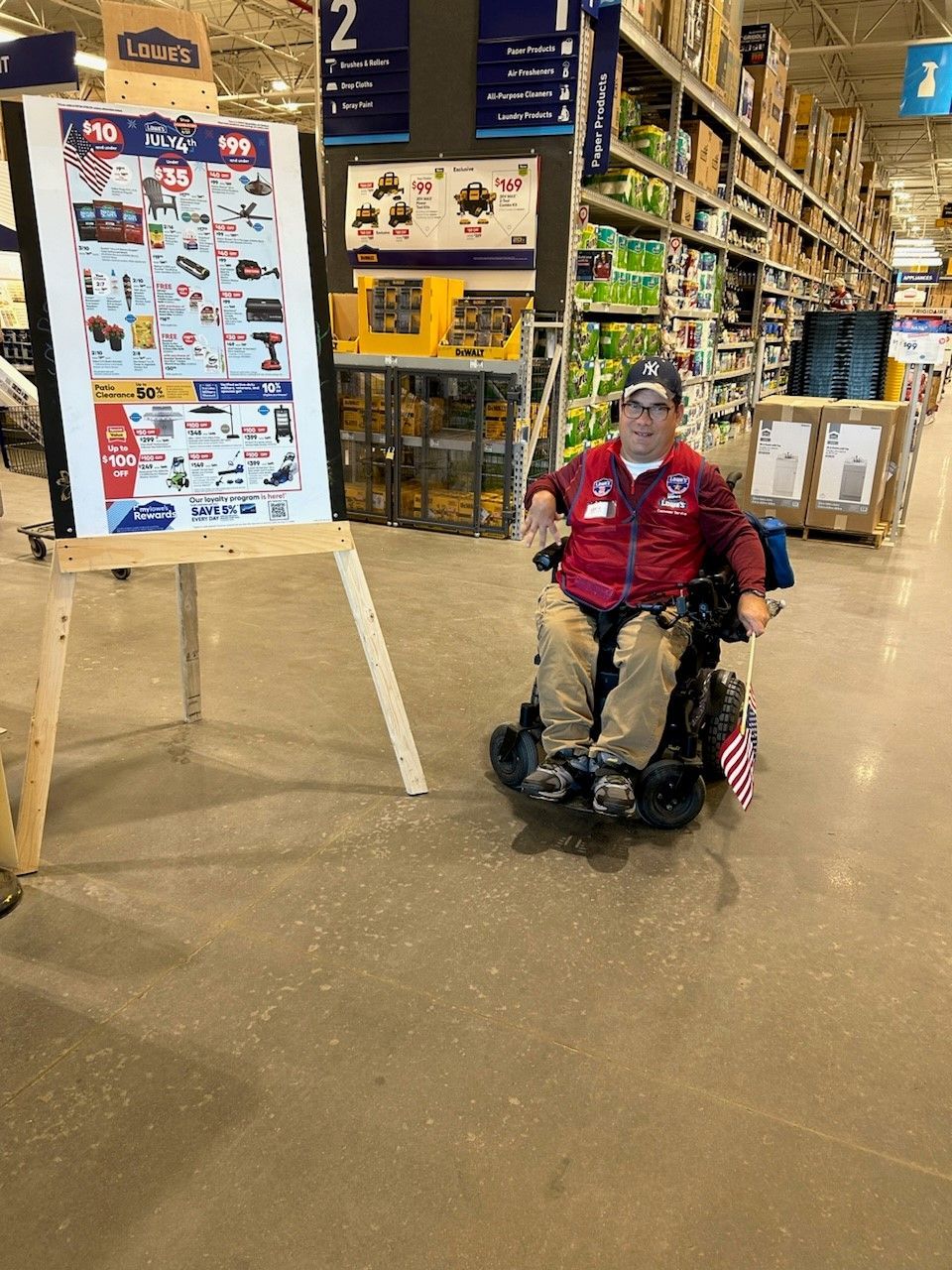 A man is greeting people at a Lowe's Home Improvement store