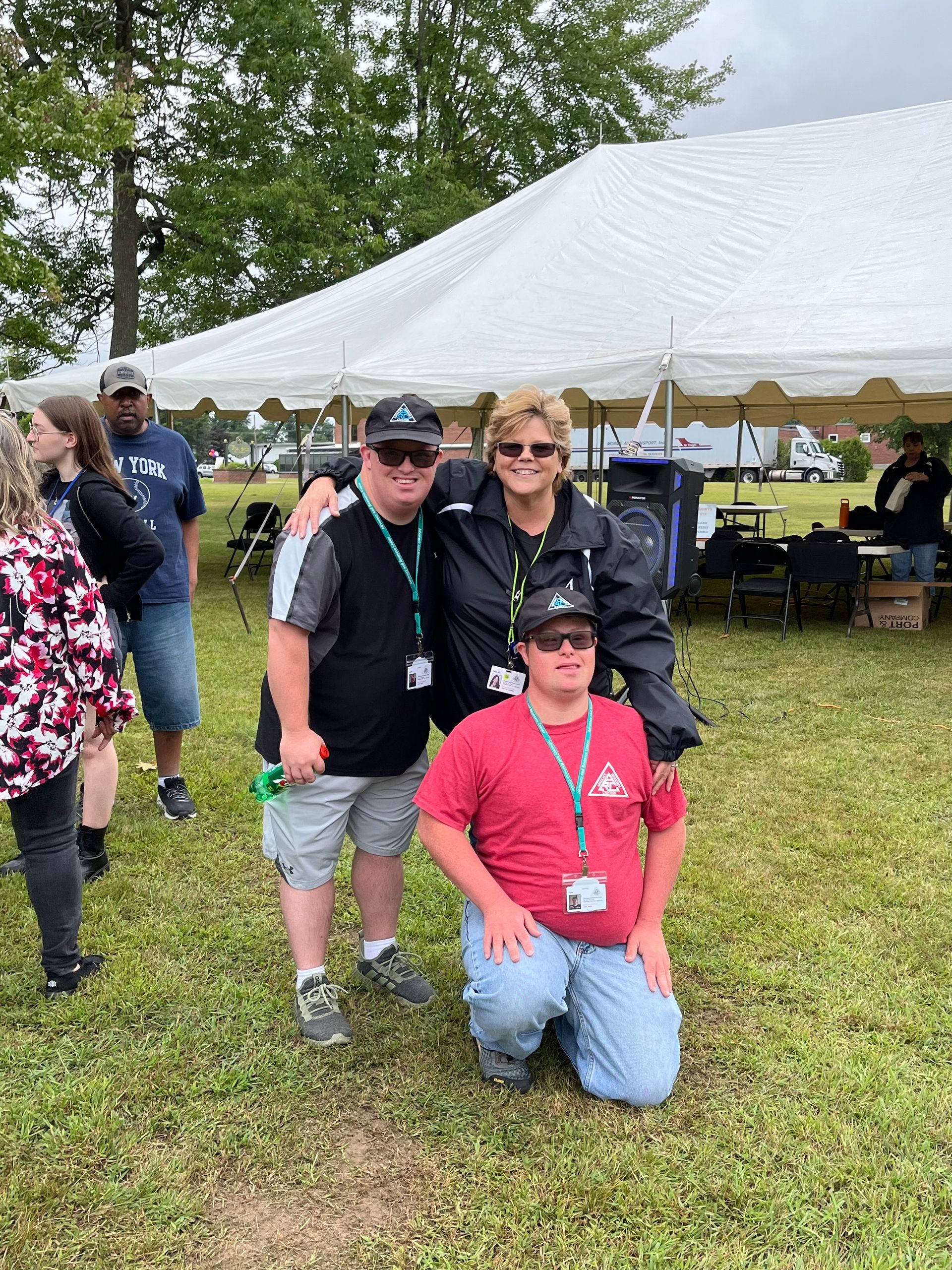 A group of people are posing for a picture in front of a tent.