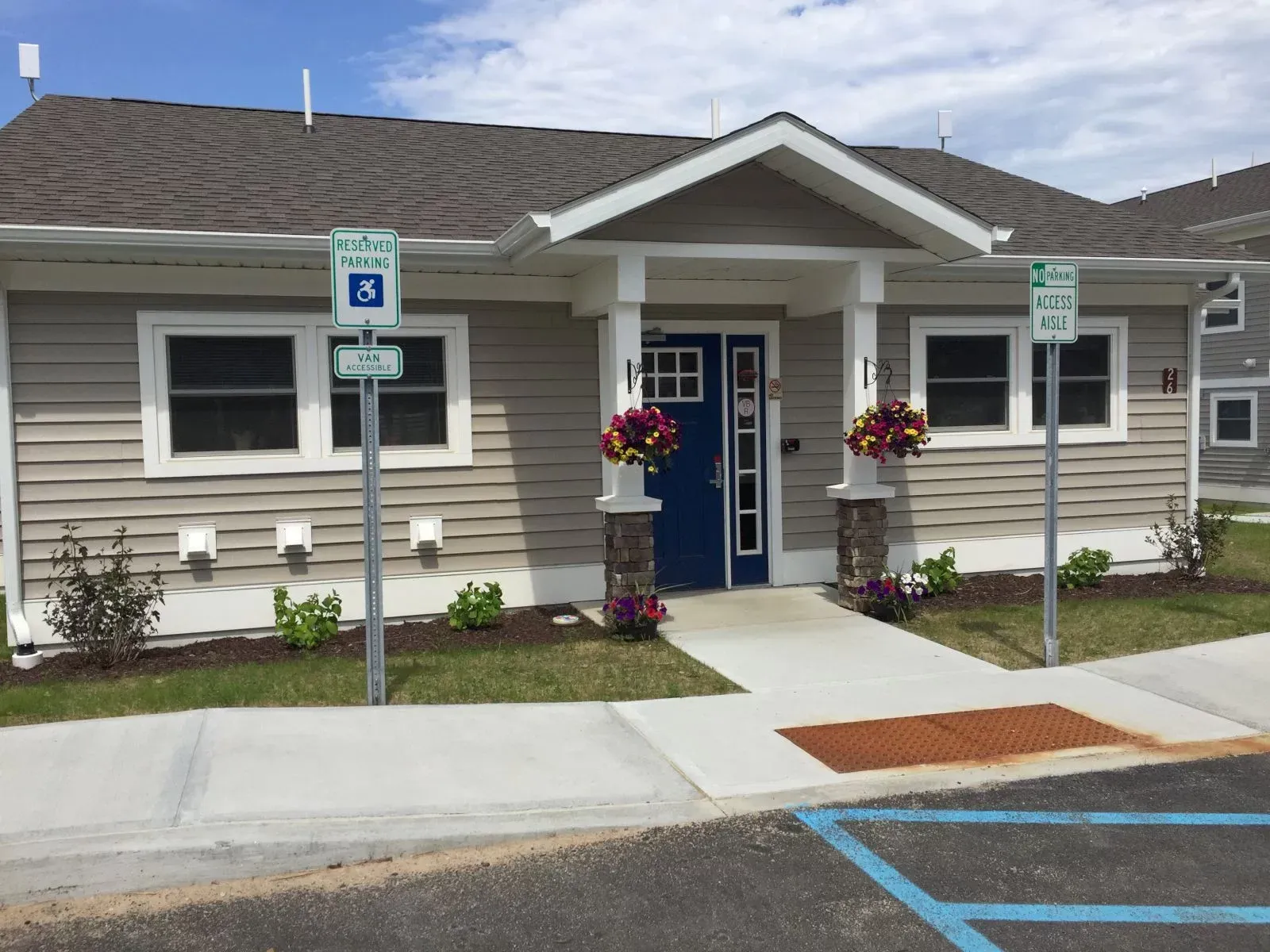 A house with a handicapped parking sign in front of it