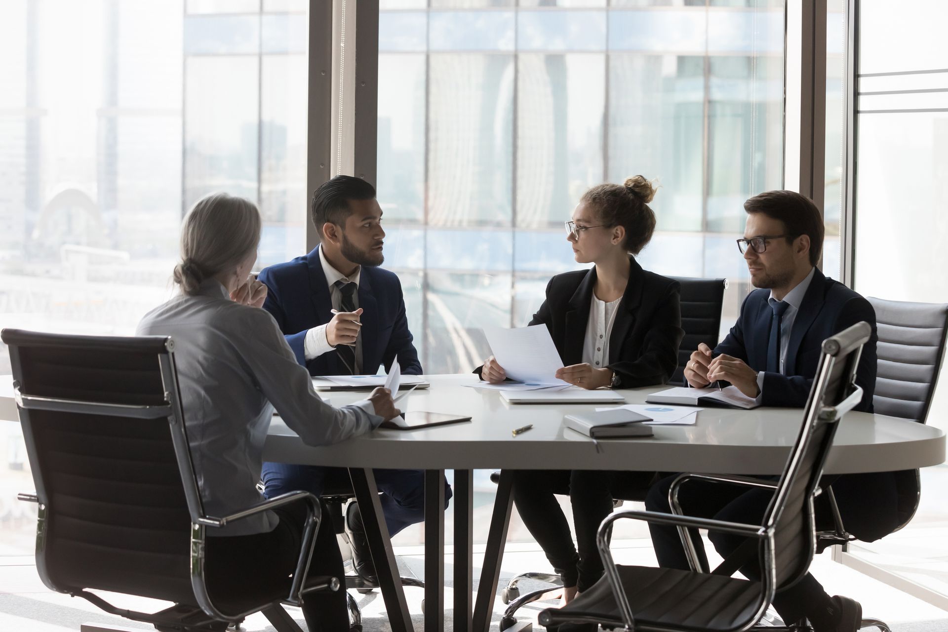 four business professionals sitting at a table