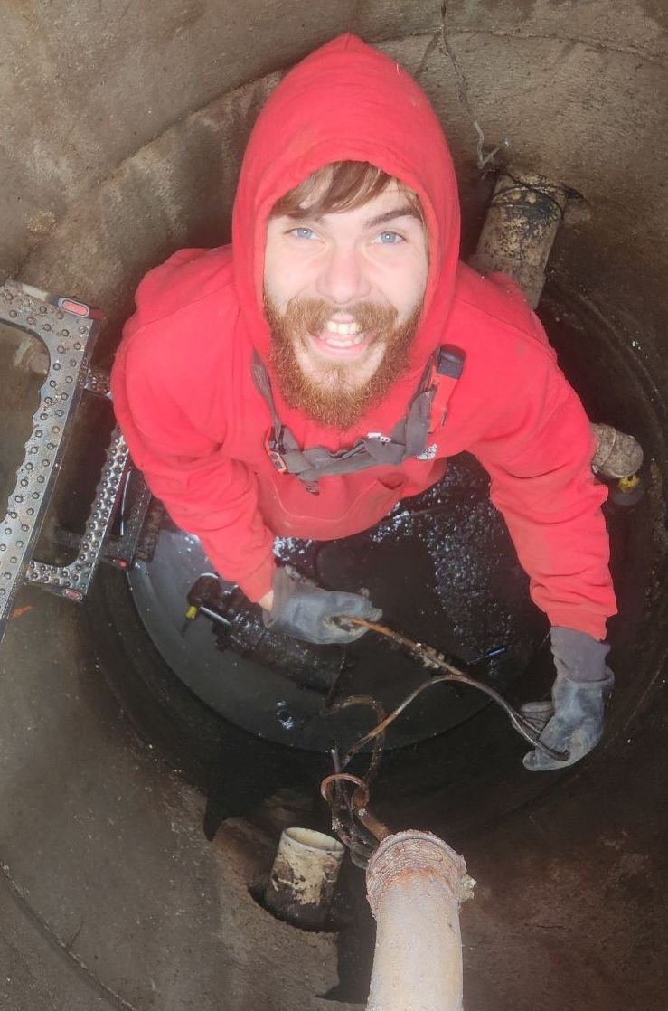 A Man in A Red Hoodie Is Standing in A Well.