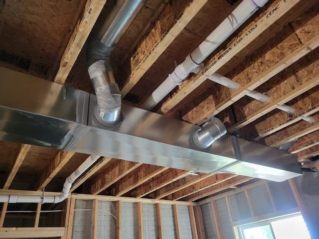 A ceiling with a lot of pipes hanging from it