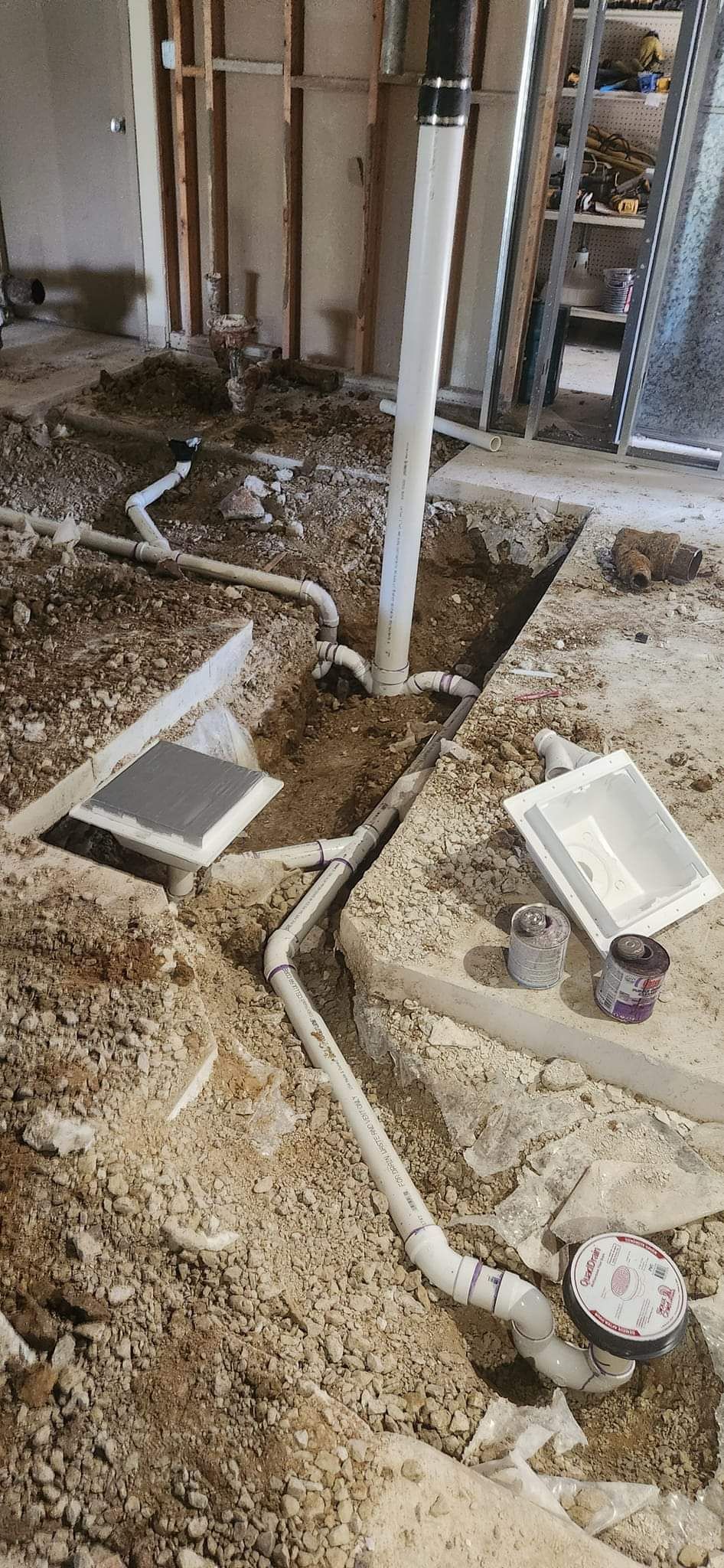 A bunch of pipes are being installed in a basement.