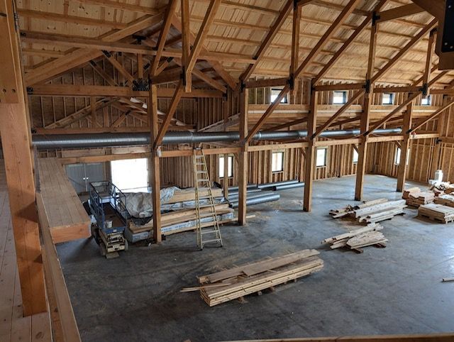 A Large Wooden Building Under Construction with A Lot of Wood in It