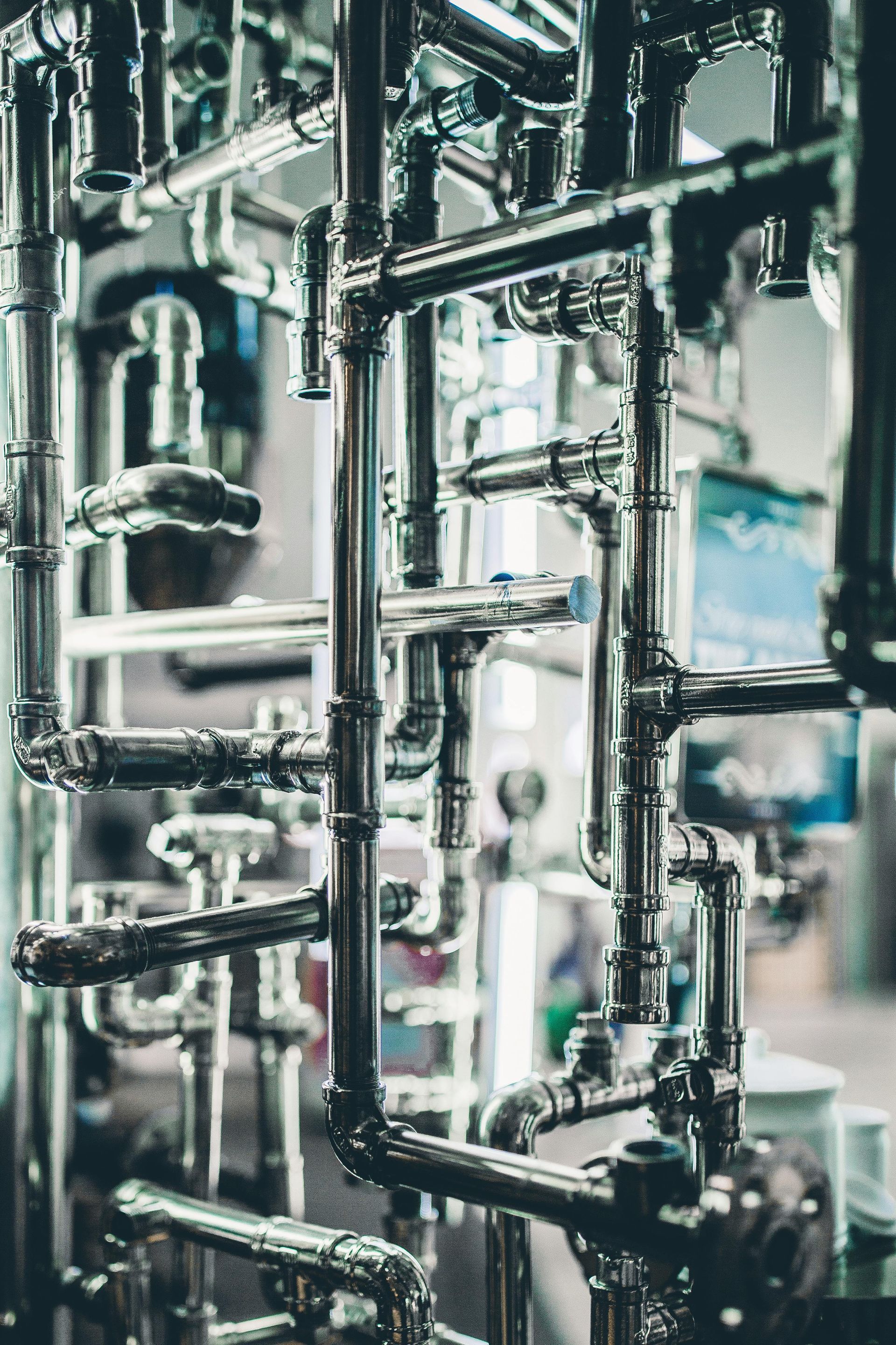 A bunch of metal pipes are stacked on top of each other in a factory.