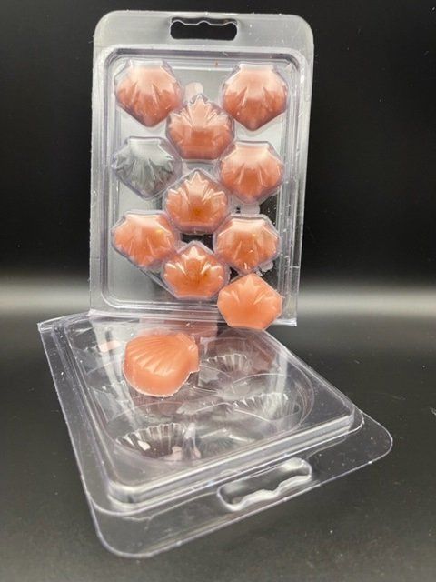 A plastic container filled with wax melts on a table.