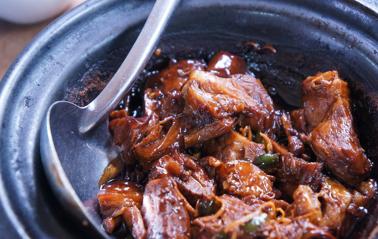 A close up of a bowl of food with a spoon in it.