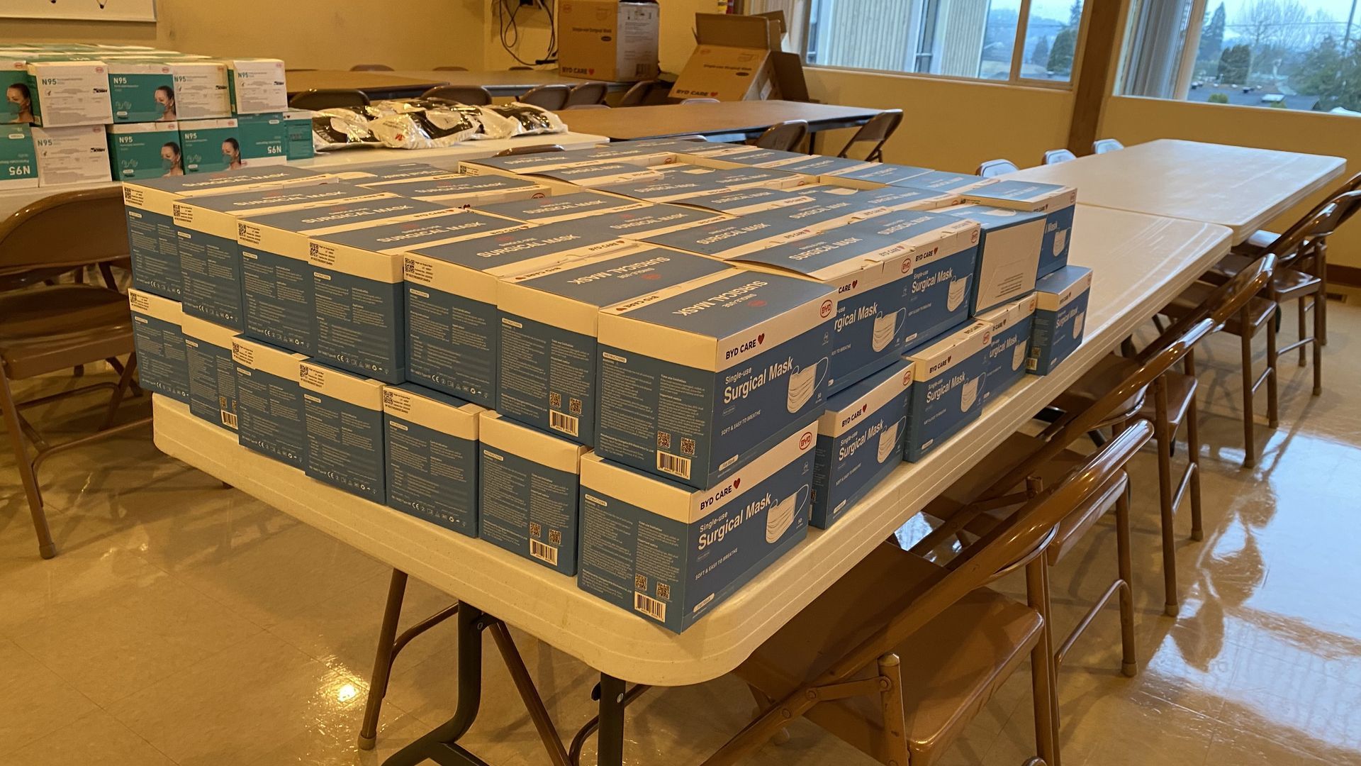 A table with boxes stacked on top of each other on it.