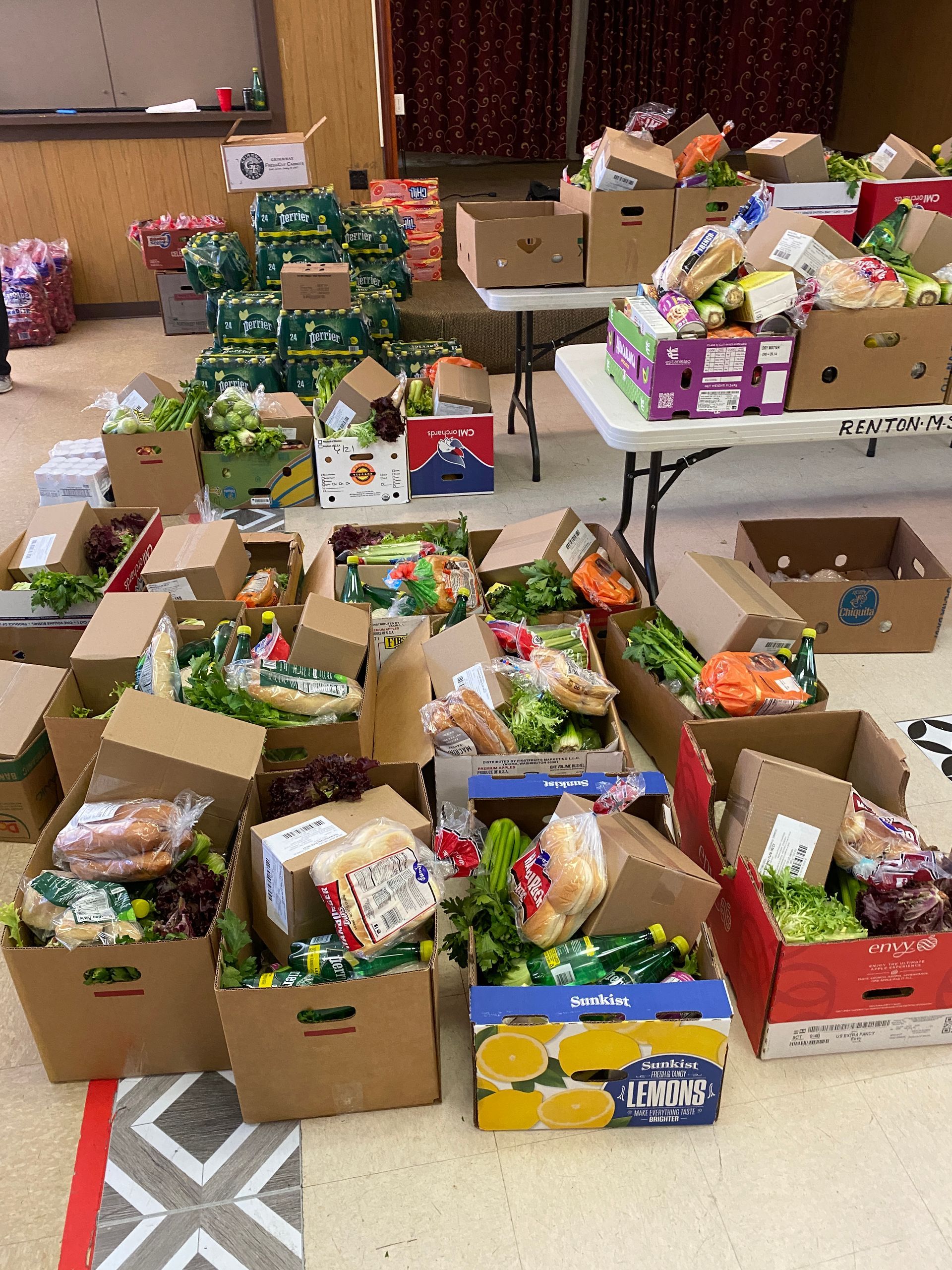 A bunch of boxes of food are sitting on a table.