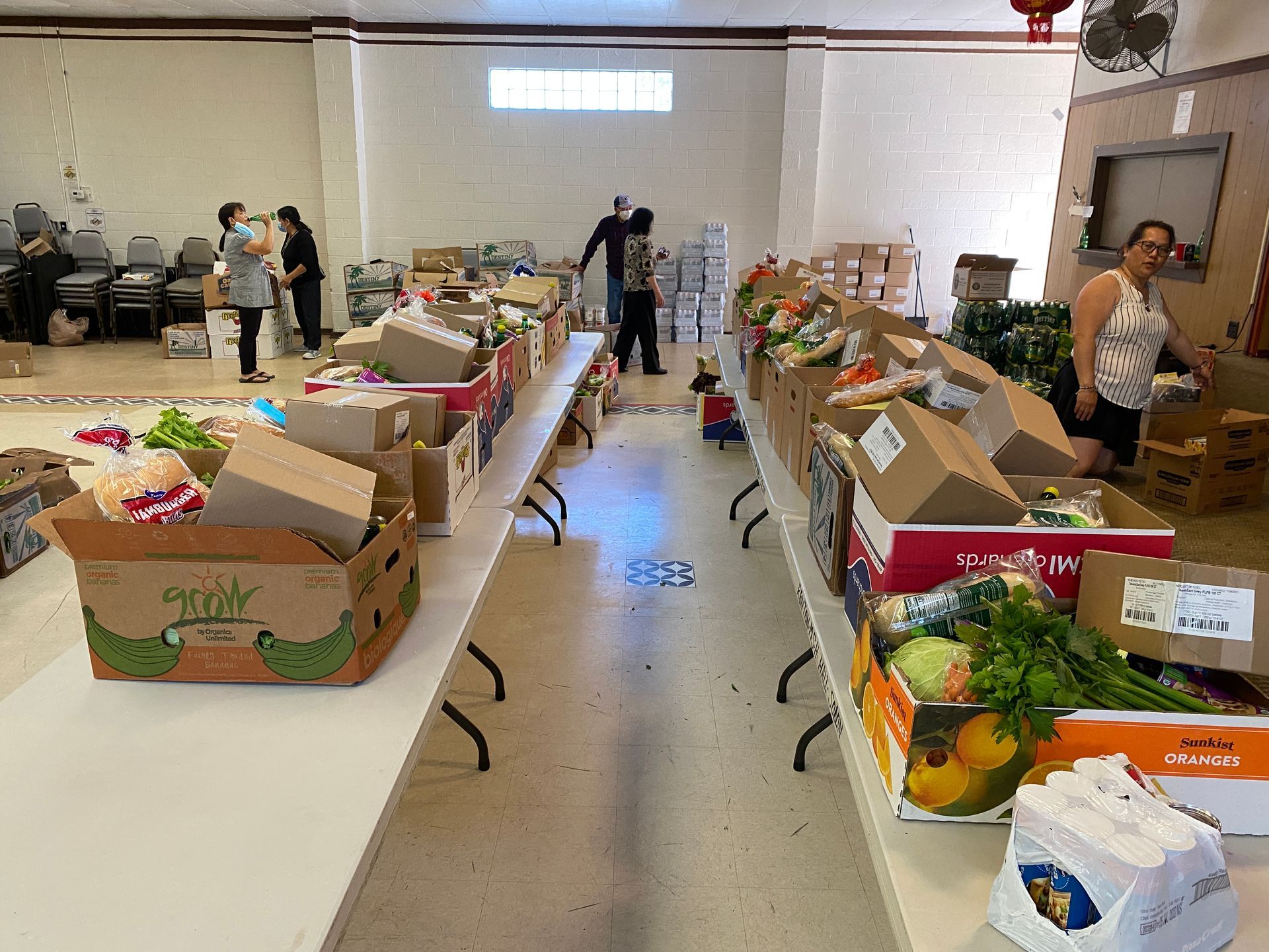 A room filled with lots of boxes of fruits and vegetables.