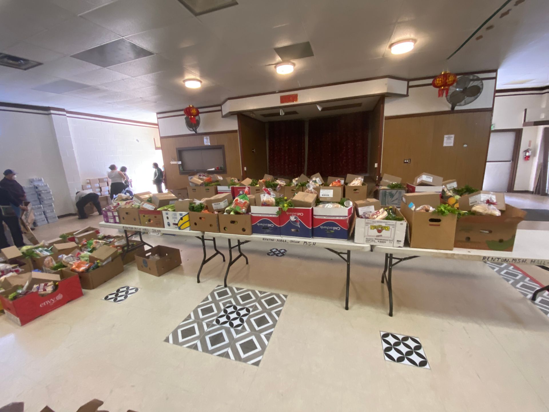 A room filled with lots of boxes of food on tables.