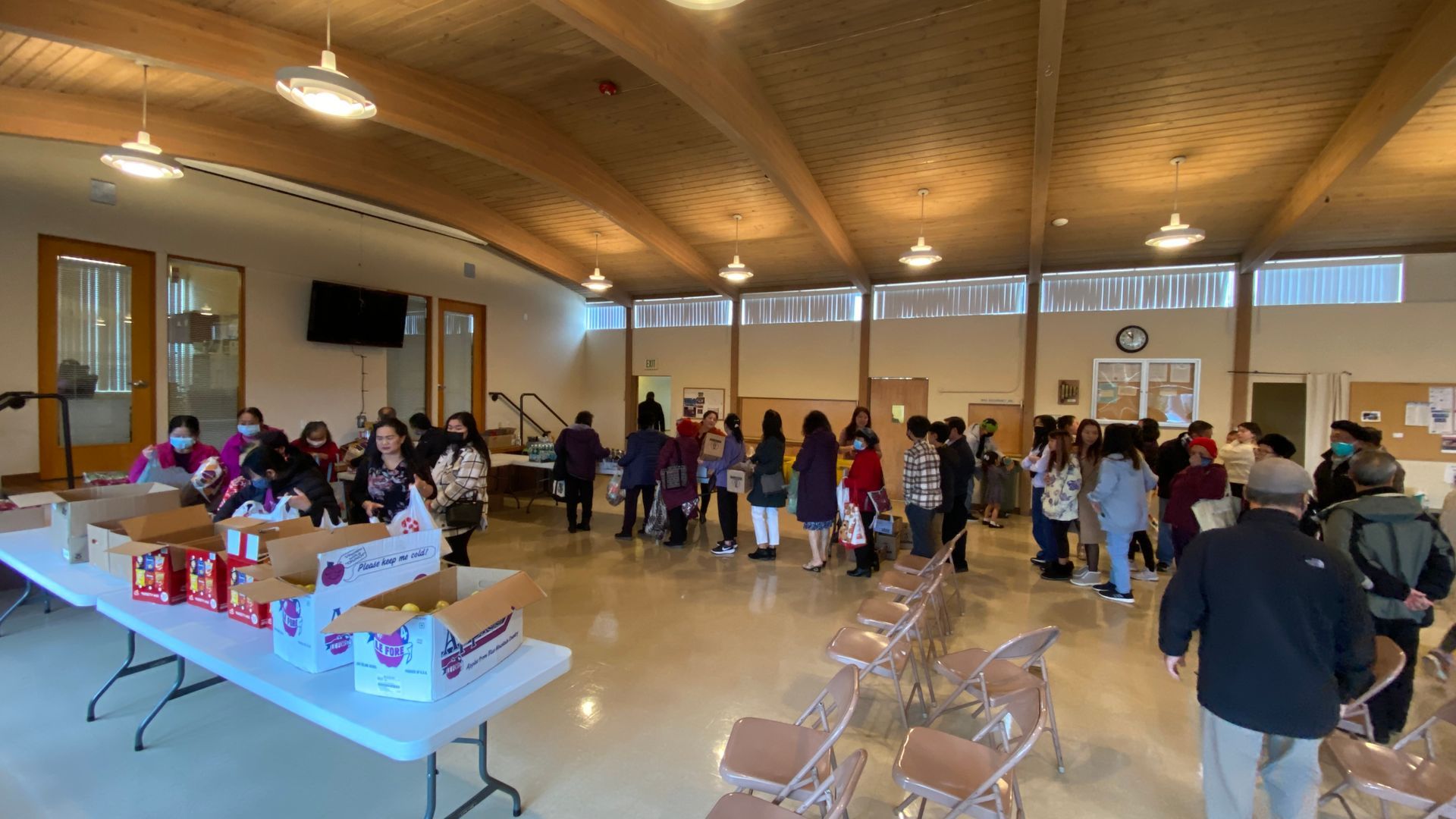 A large group of people are gathered in a large room.