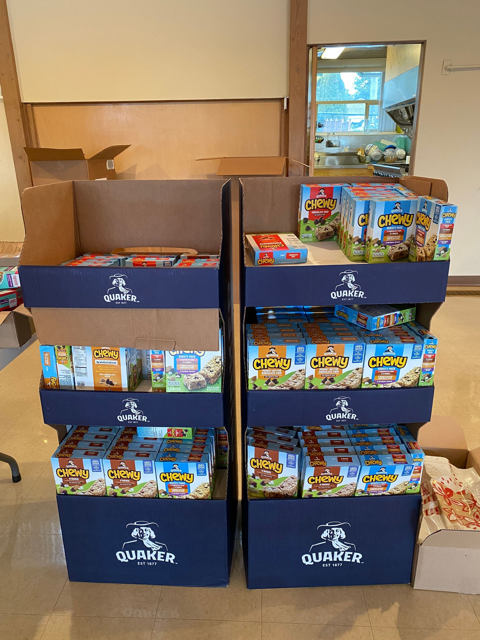 A display of cereal boxes on a table in a room.