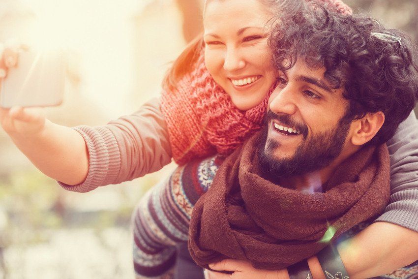 Man and woman walking with arms round each other