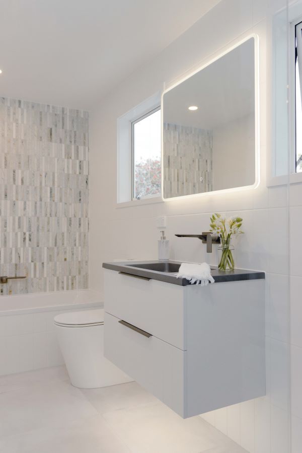 A bathroom with a sink , toilet , and mirror.