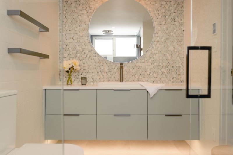A bathroom with a sink , mirror and toilet.