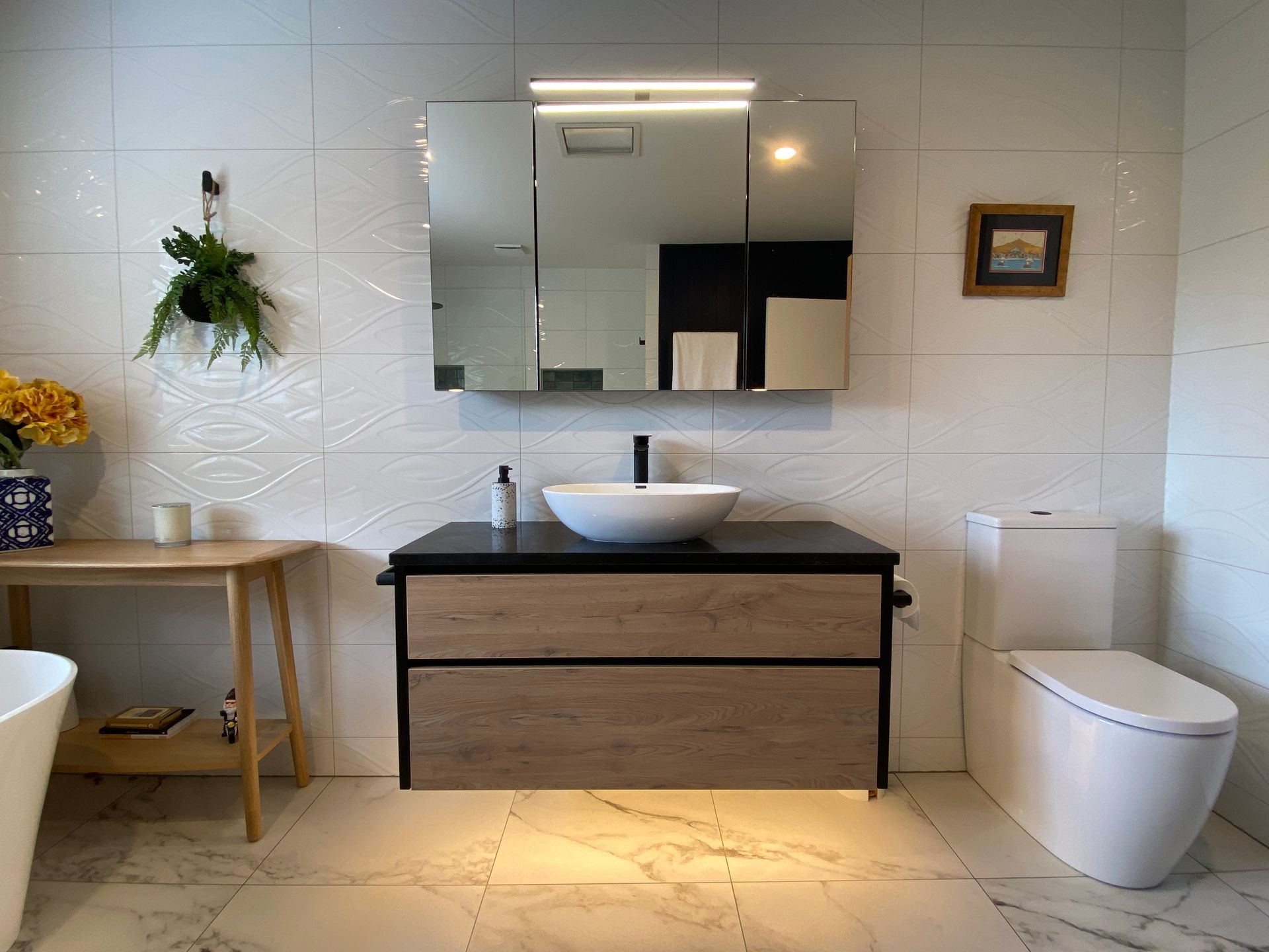 A bathroom with a sink , toilet , and mirror.