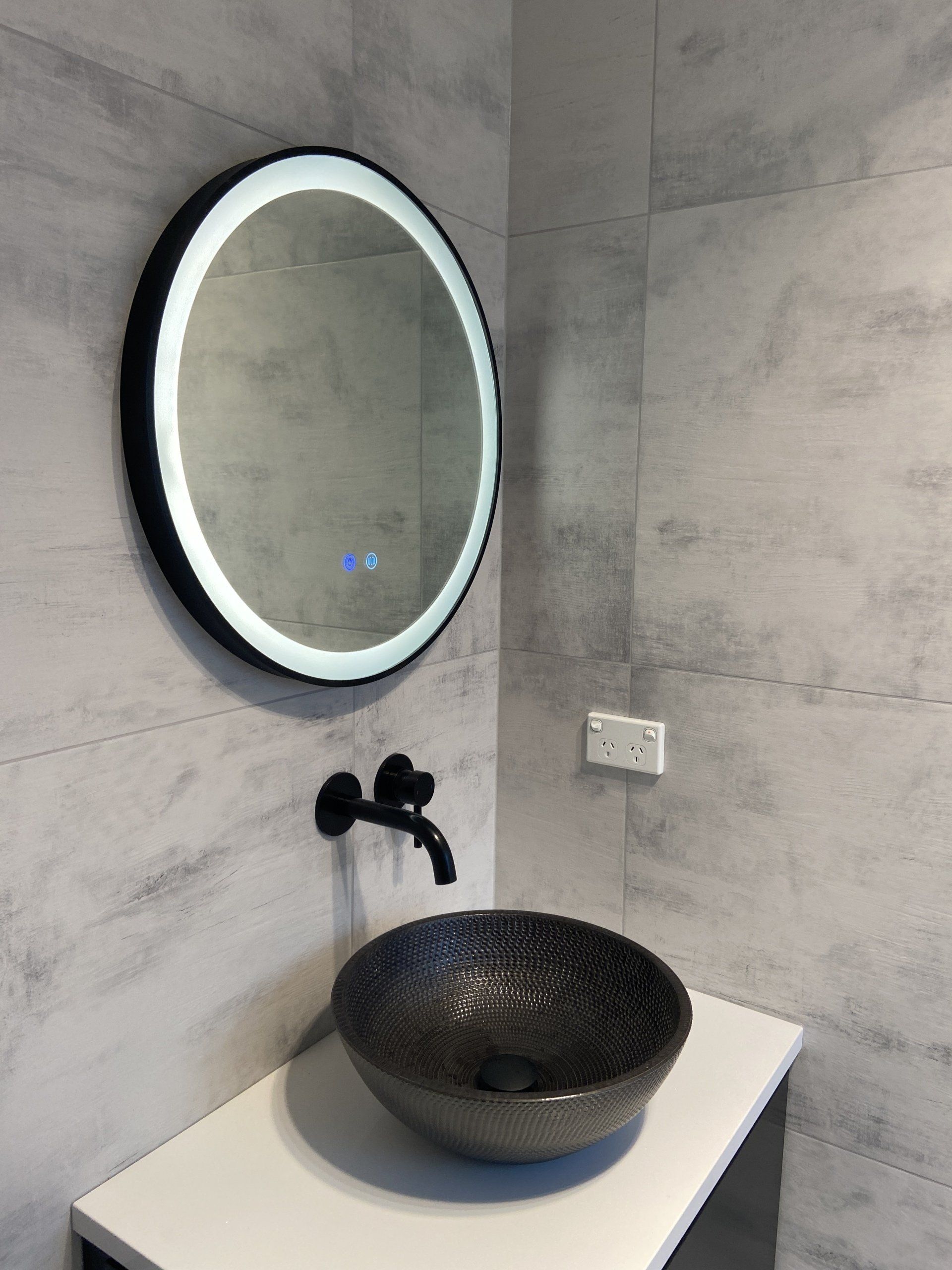 A bathroom with a sink and a mirror on the wall