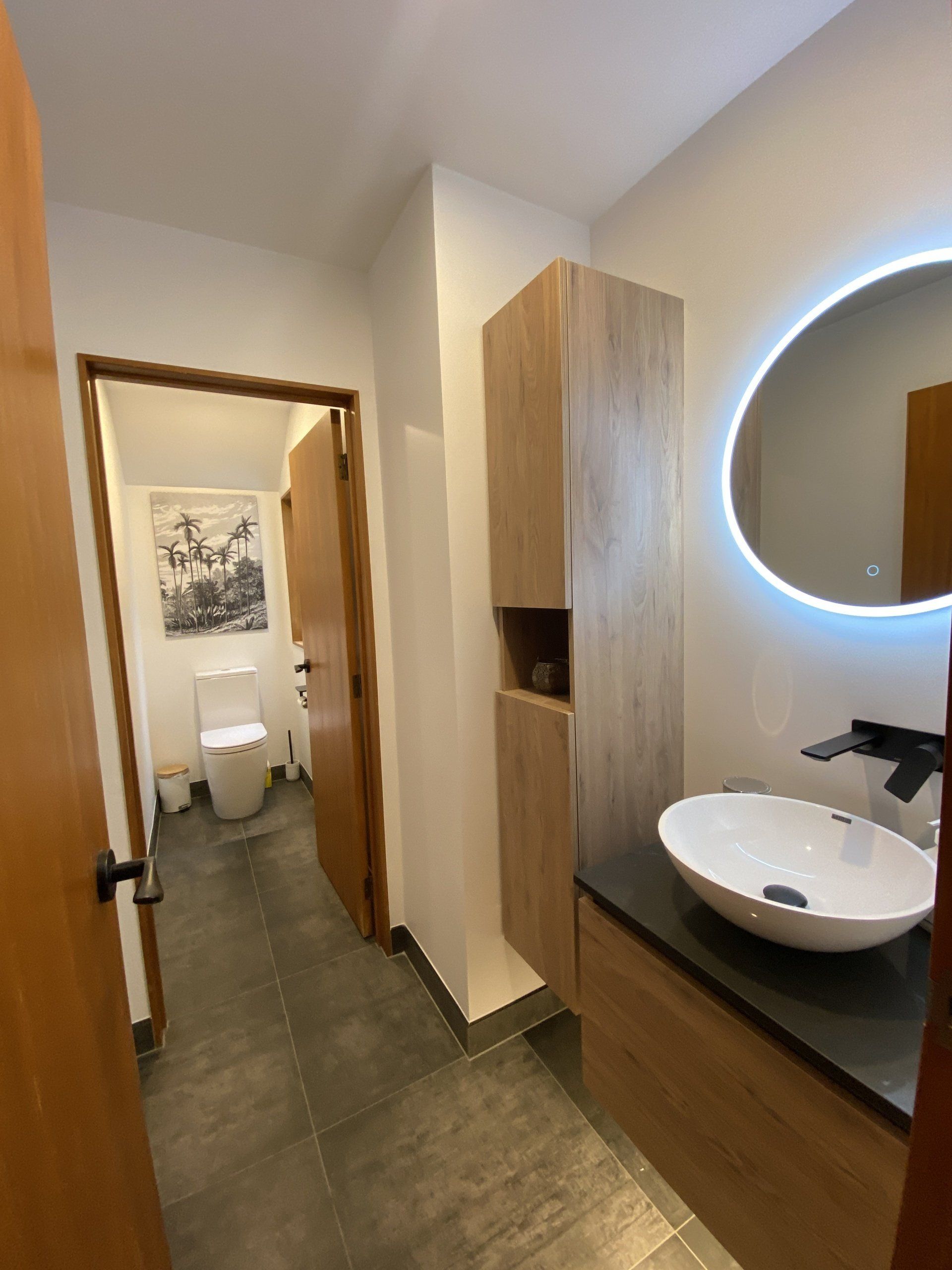 A bathroom with a sink , toilet and mirror.