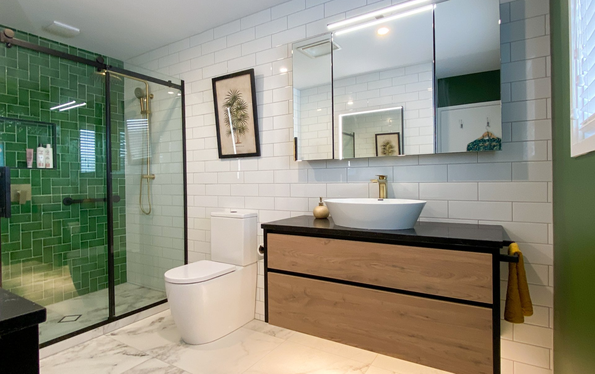 A bathroom with a toilet , sink , and shower.