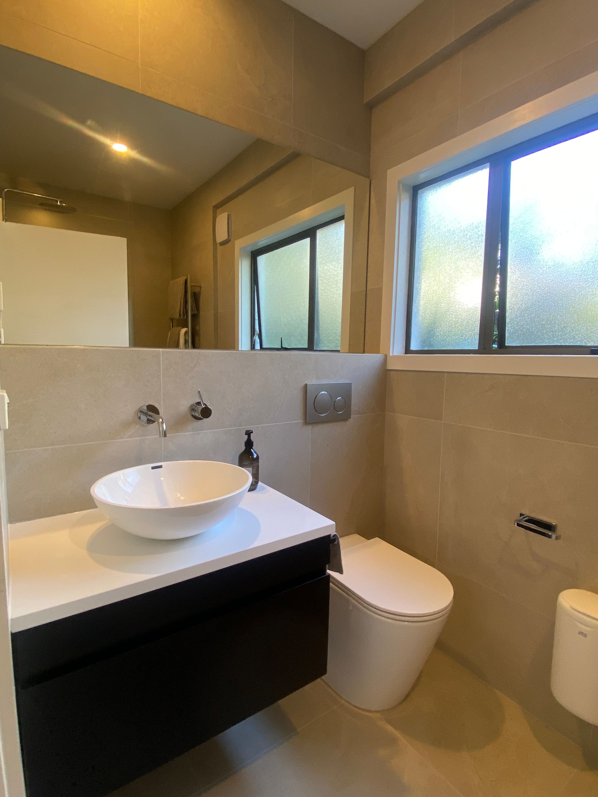 A bathroom with a sink , toilet and mirror