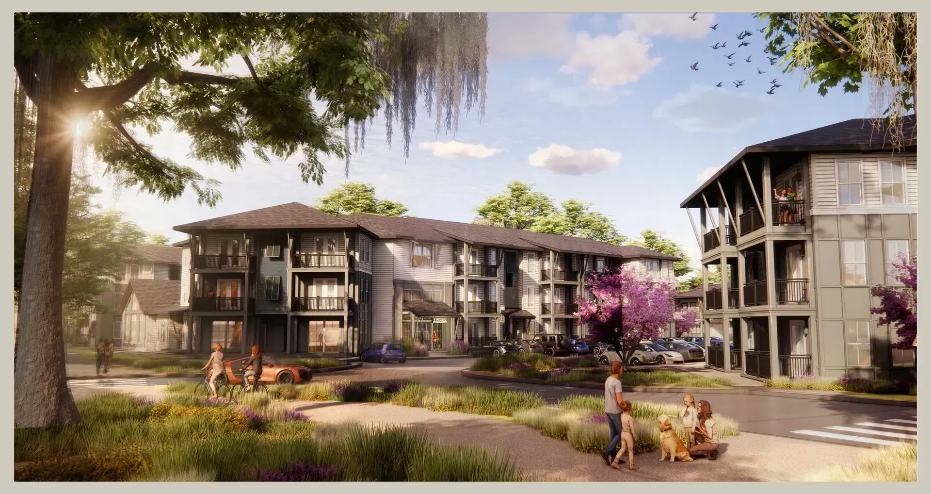 Modern apartment complex with balconies, landscaped courtyard, and people walking on a sunny day